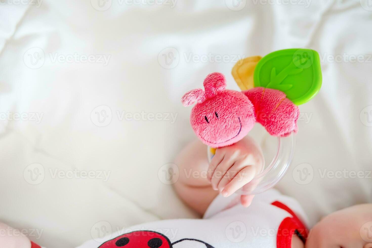 The little baby sleeps folding its legs one on top of the other. Small pink heels of a newborn baby dressed in a diaper. photo