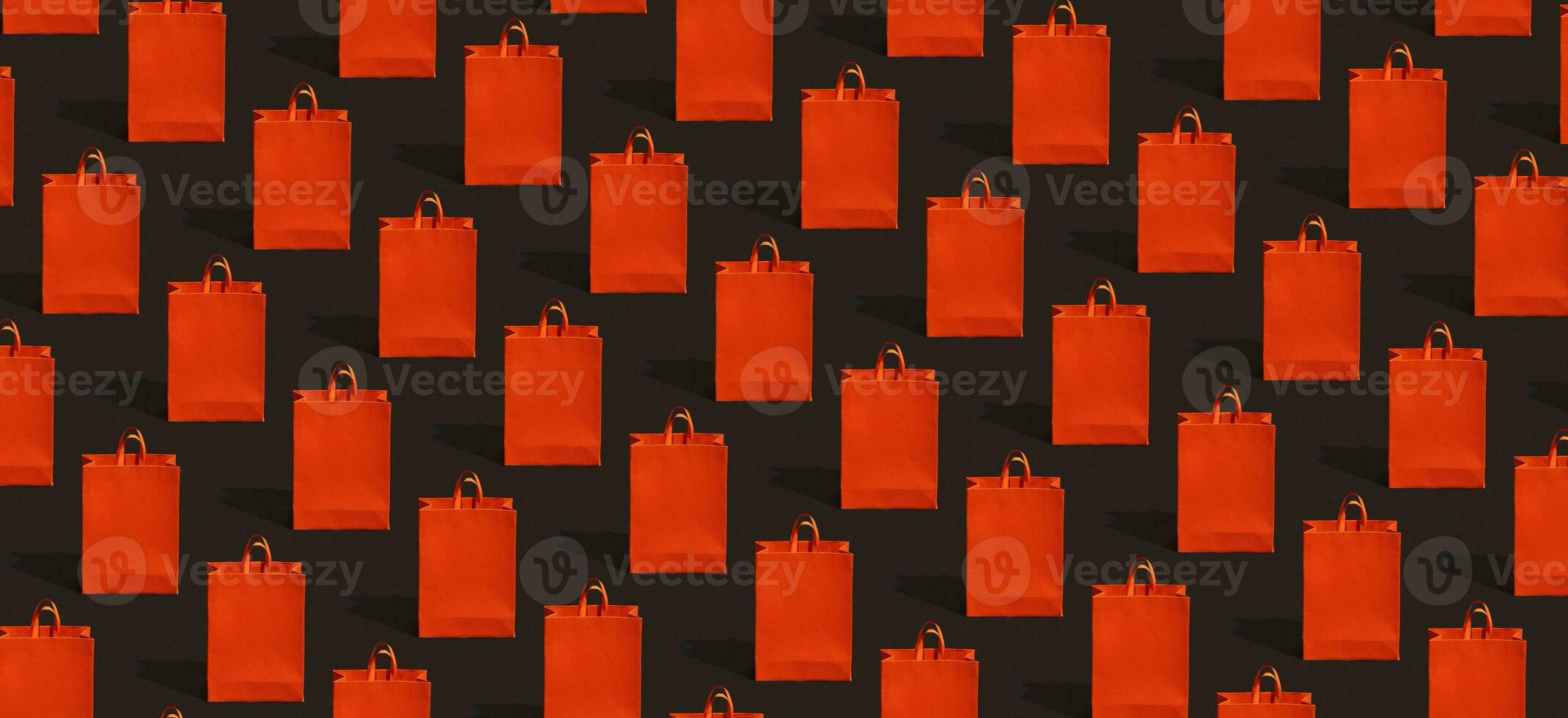 Black friday sale, shopping concept. Red paper shopping bag pattern on black background. photo