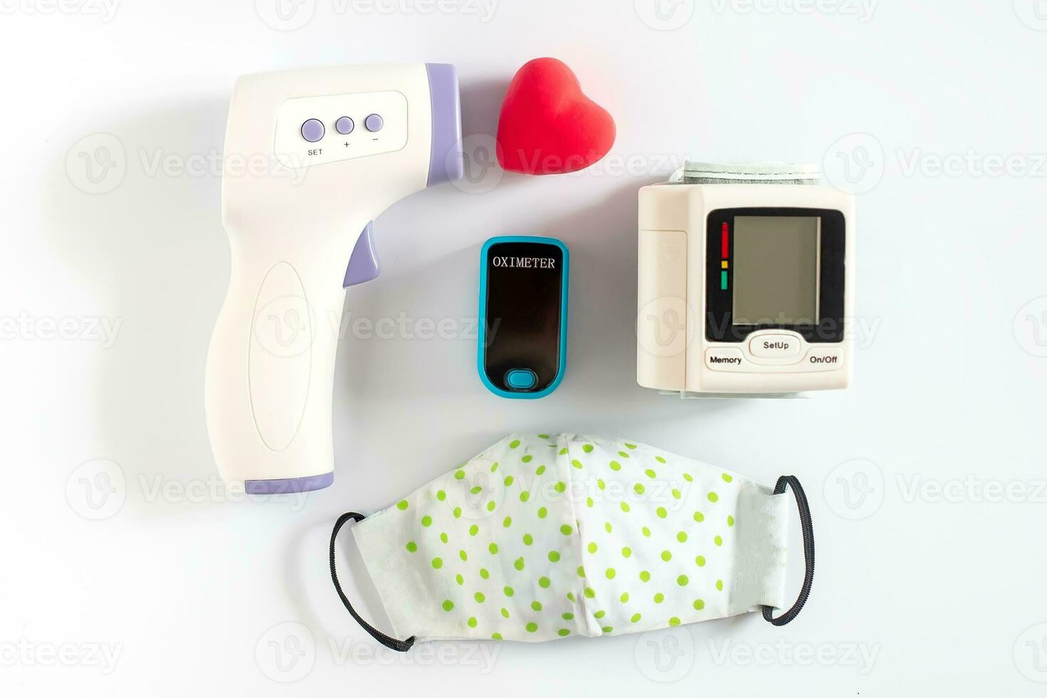 infrared contactless thermometer next to voluminous heart on white background with trend shadows. Heart disease. Measuring temperature. Health concept. photo