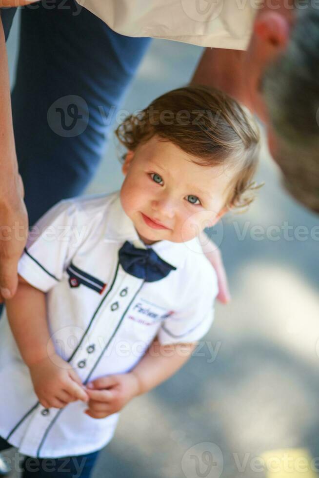 Little beautiful boy in the arms of his father. photo