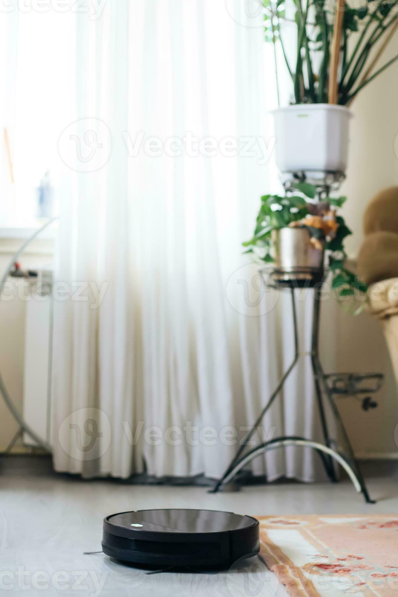 Robot vacuum cleaner drives on carpet. obstacles with robot