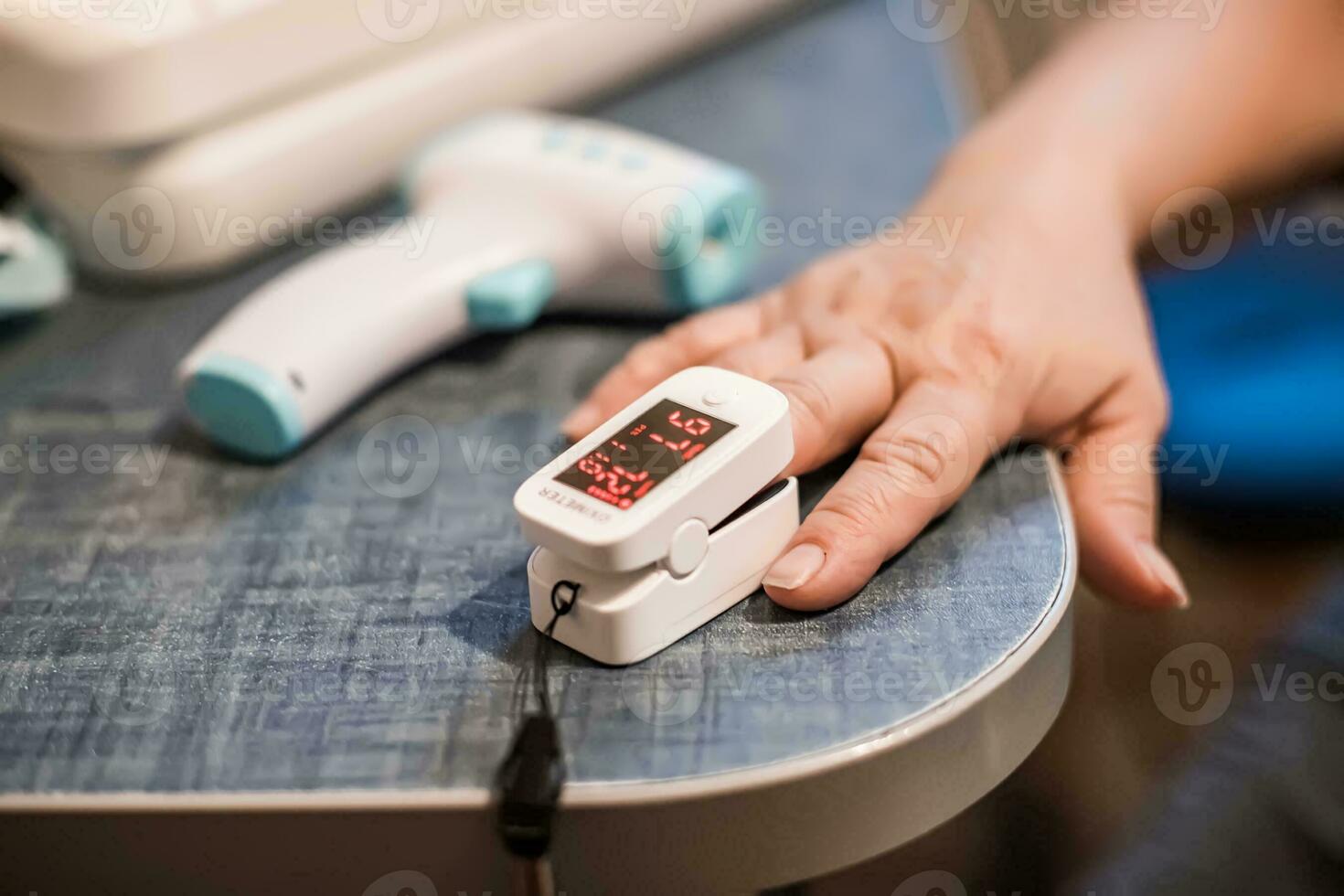 Measuring Oxygen Saturation in Blood with Pulse Oximeter for instance caused by coronavirus. Device on Caucasian female hand. photo