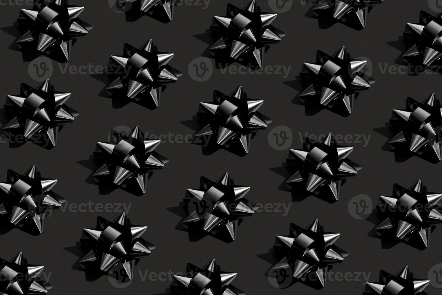 Shiny black bow on a black background. Black friday monochrome concept. photo