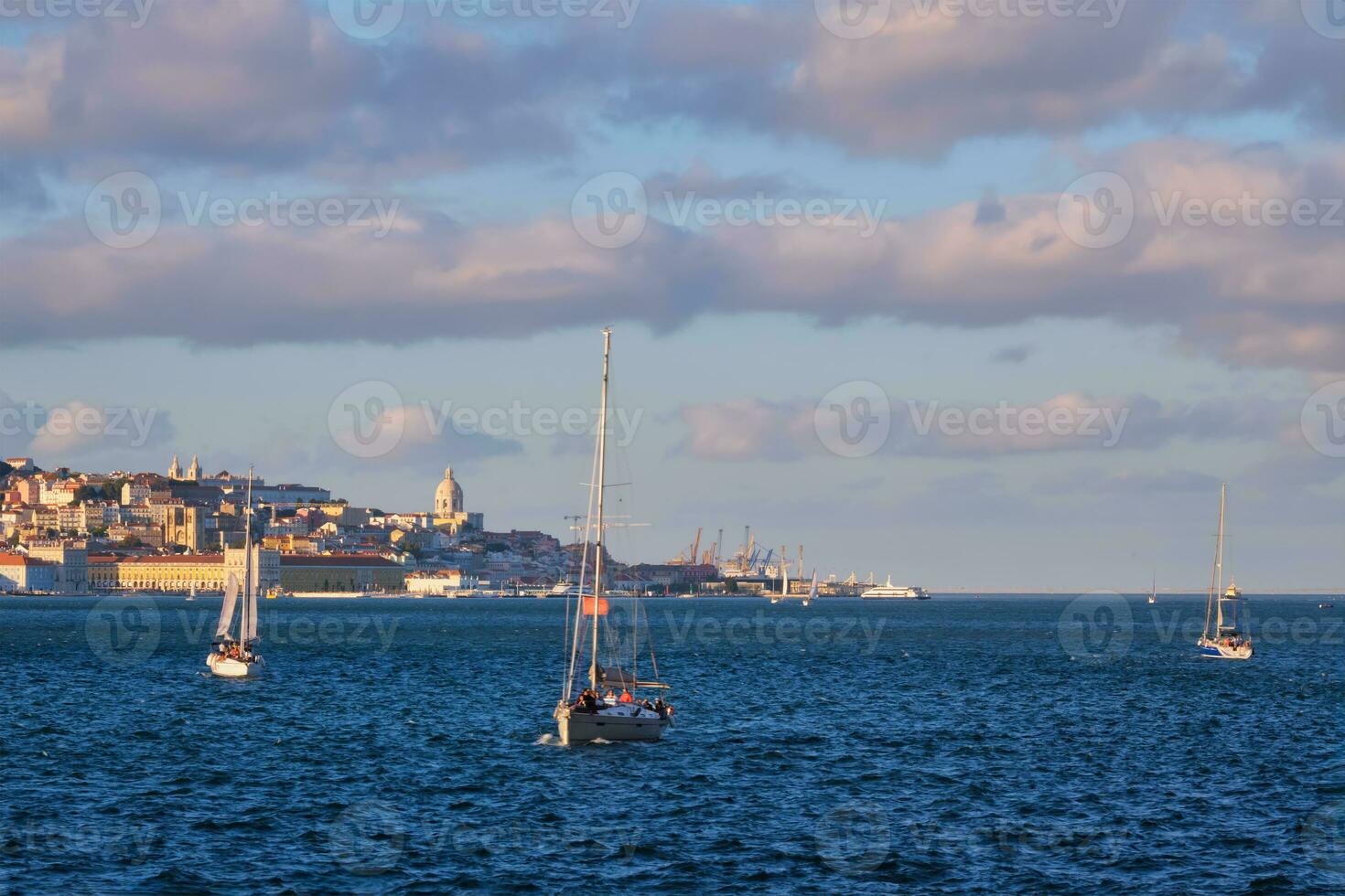 View of Lisbon view over Tagus river with yachts and boats on sunset. Lisbon, Portugal photo