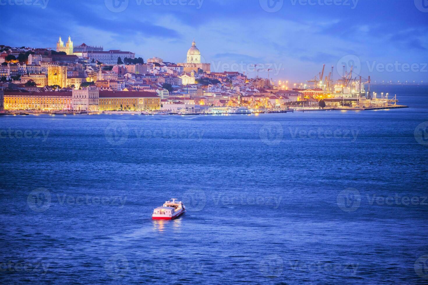 View of Lisbon view over Tagus river with yachts and boats on sunset. Lisbon, Portugal photo