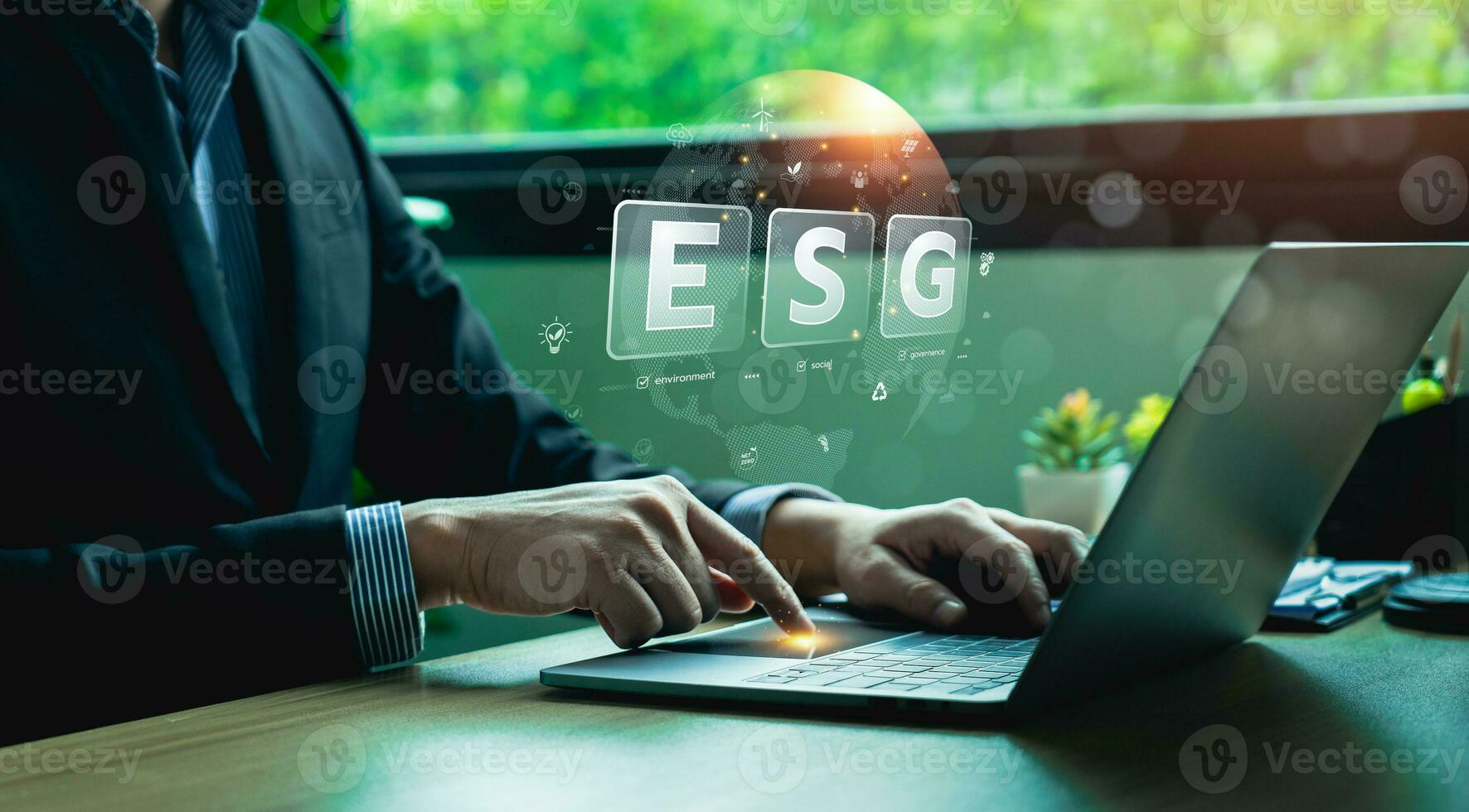 ESG environment social governance investment concept. Businessman using computer to analyze investment ESG. strategy that considers the environmental, company carbon labor practices, sustainability photo