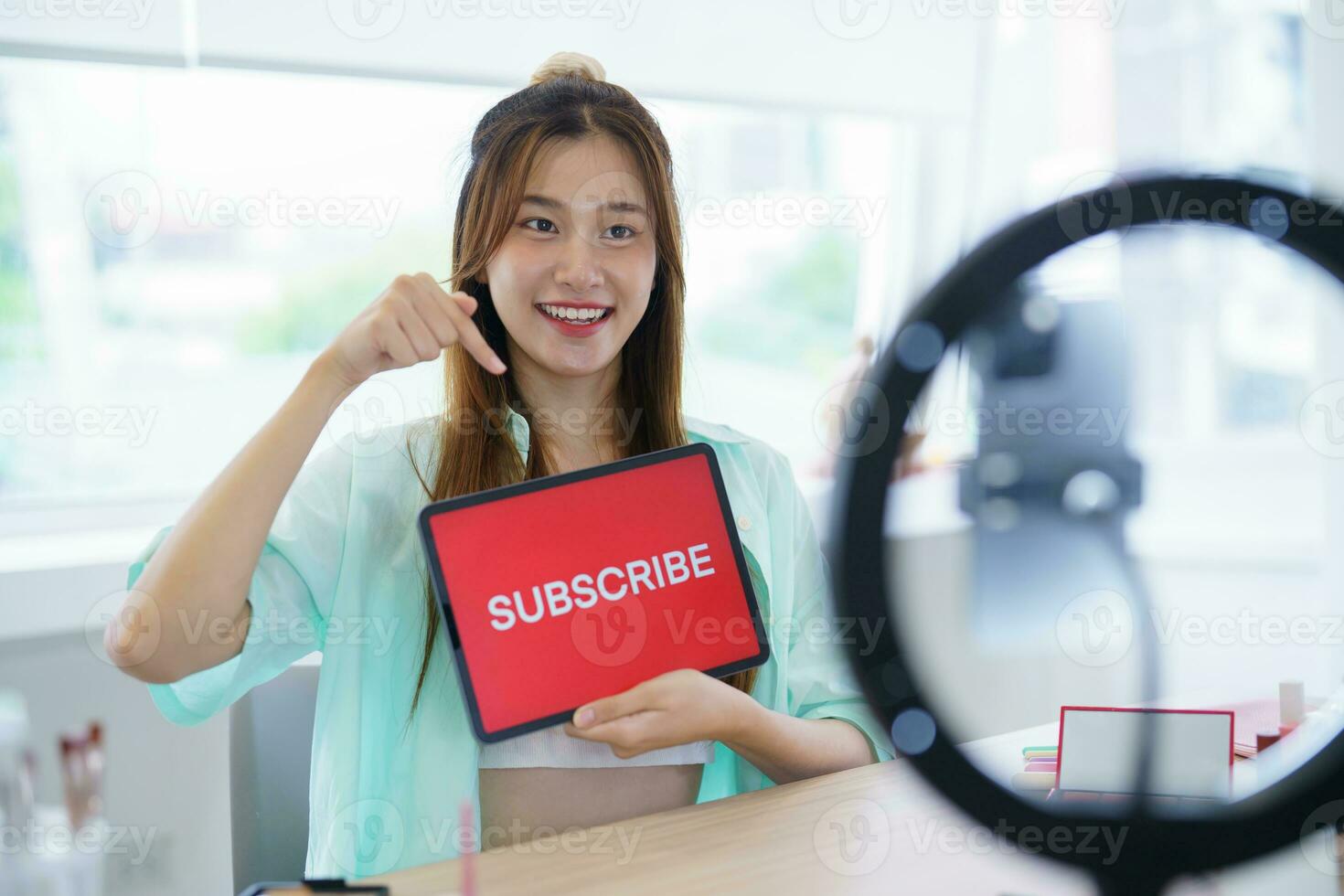 Online marketing Beauty influencer Asian girl Using Social Media for live streaming on Smartphone online audience like and subscribe to her channel. Like Follower photo