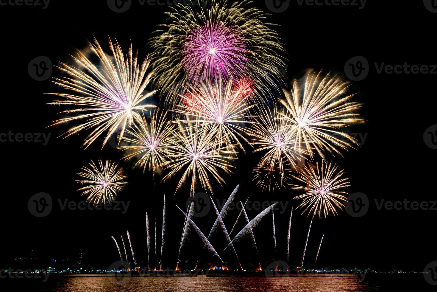 Amazing beautiful colorful fireworks display on celebration night, showing on the sea beach with multi color of reflection on water photo