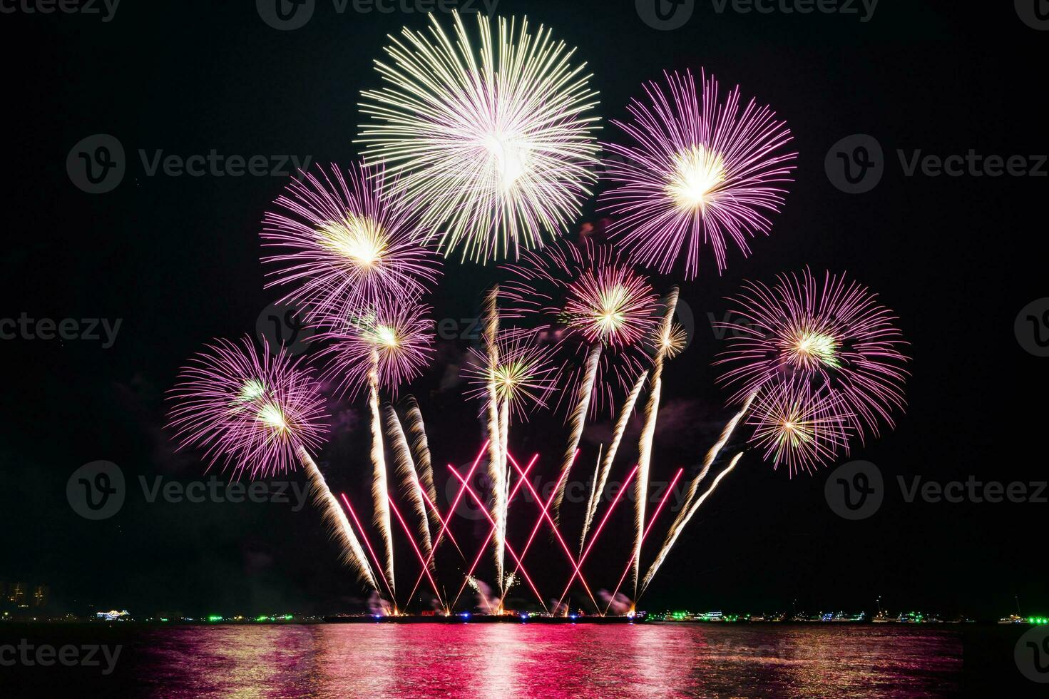 Amazing beautiful colorful fireworks display on celebration night, showing on the sea beach with multi color of reflection on water photo
