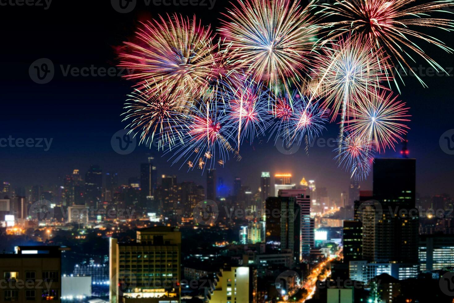 Amazing beautiful colorful fireworks display on celebration night, showing on the sea beach with multi color of reflection on water photo