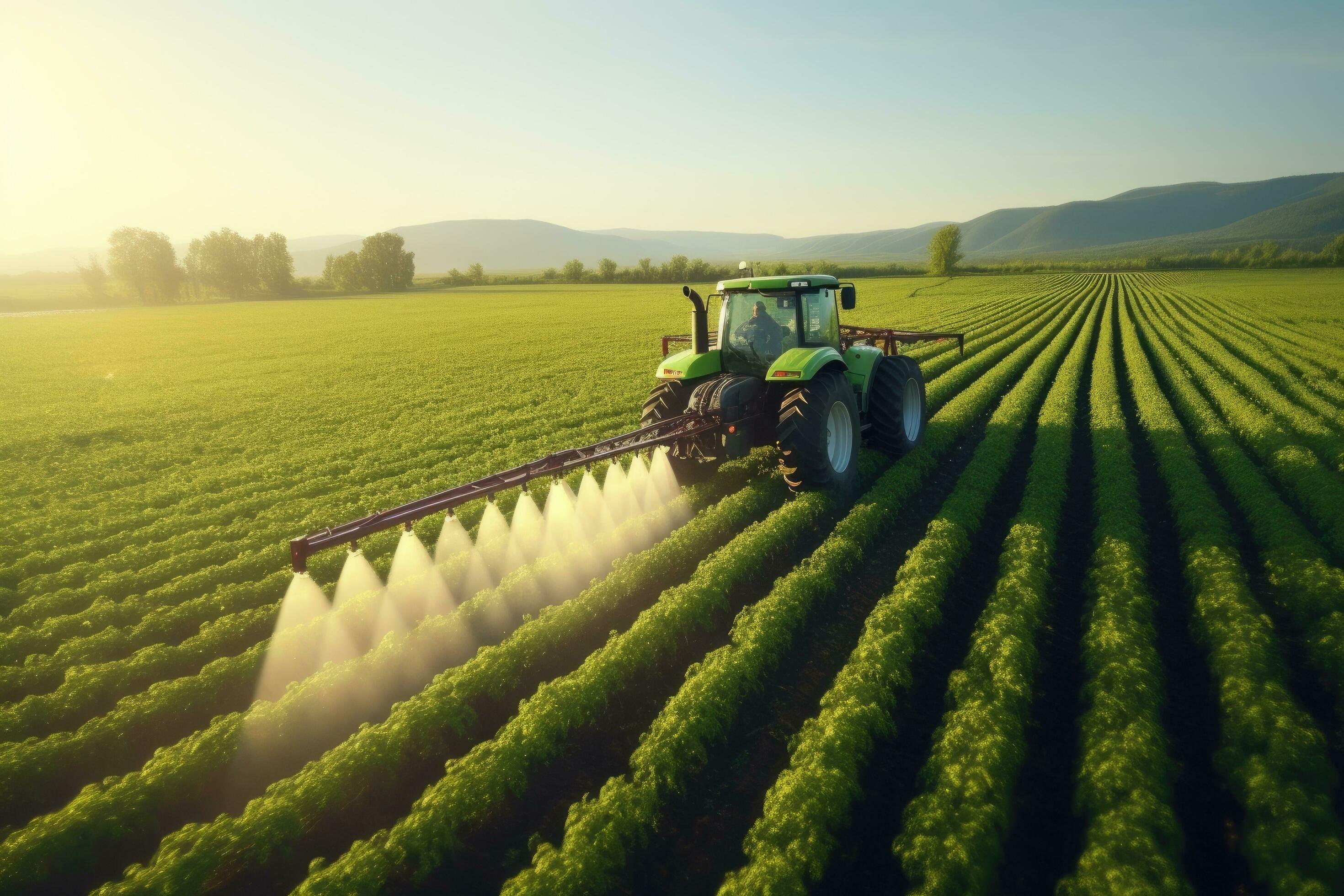 Tractor spraying pesticides on soybean field with sprayer at spring