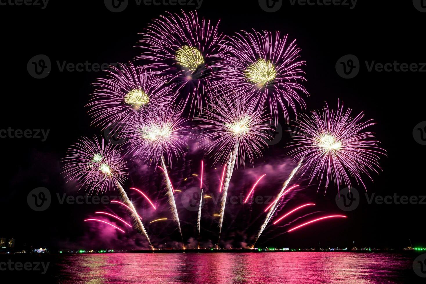 Amazing beautiful colorful fireworks display on celebration night, showing on the sea beach with multi color of reflection on water photo