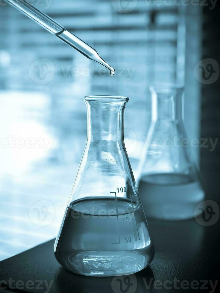 Laboratory glassware at lab background in blue tone photo