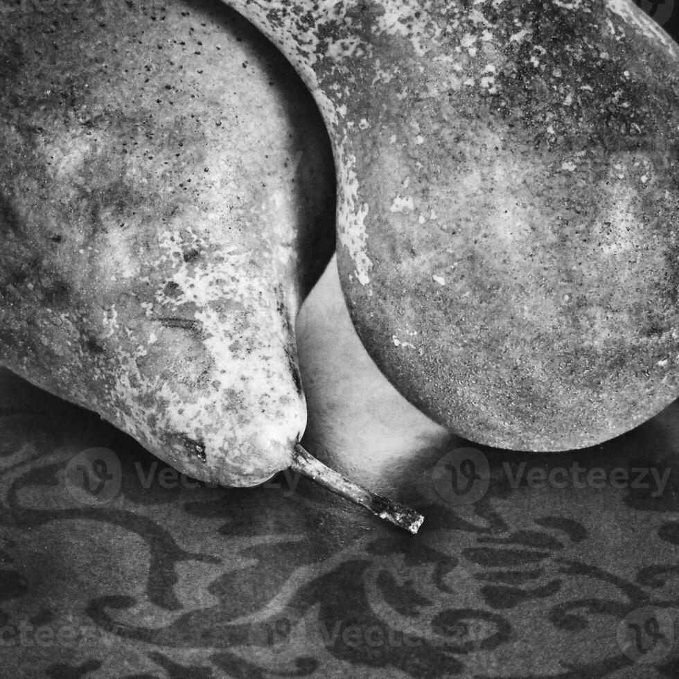 still life with pears on a wooden background photo