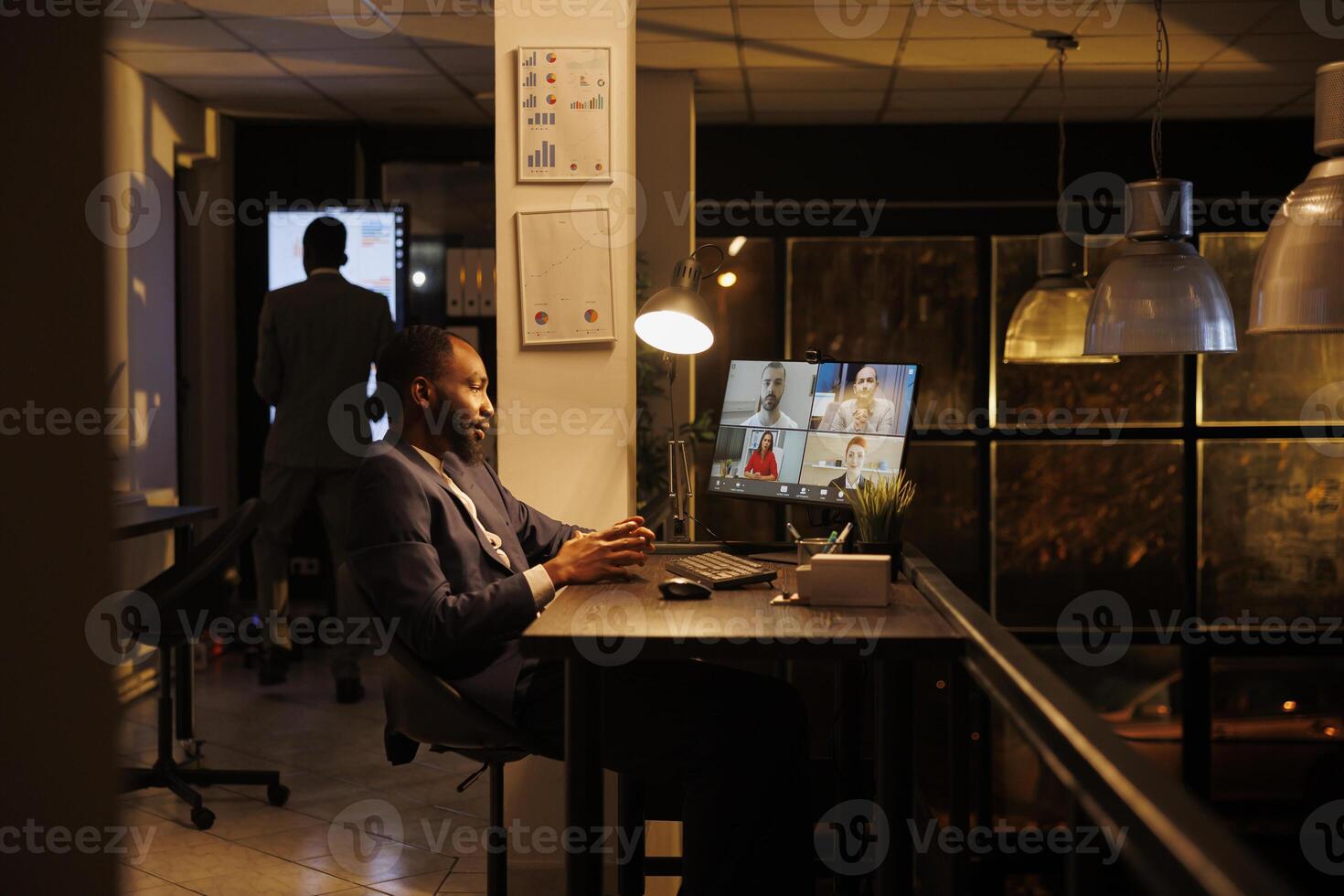 Businessman explaining marketing strategy to remote team during online videocall meeting conference in startup office. Colleagues discussing financial statistics, working overtime at growth report photo