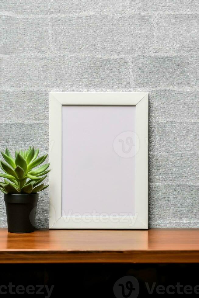 Empty vertical picture frame mockup hanging on a brick wall with wooden desk table and flower vase AI Generated photo