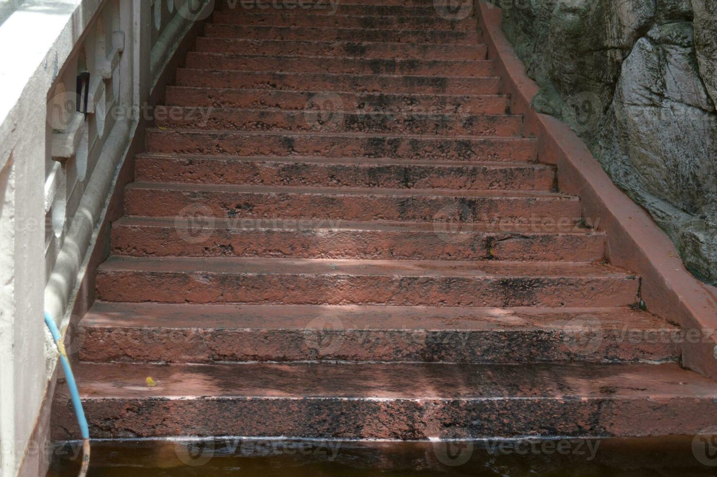 old cement stairs There are traces of use for a long time and there is a crack in the floor photo