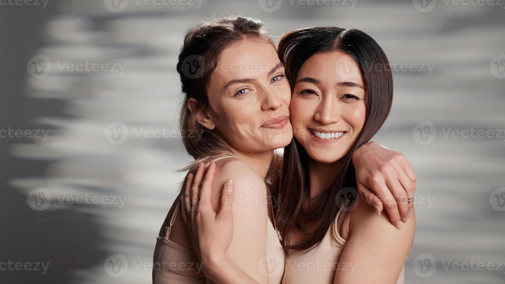 Cheerful beauty models posing on camera for campaign, advertising self acceptance and skincare products. Happy friends with different skintones promoting diversity and body confidence. photo