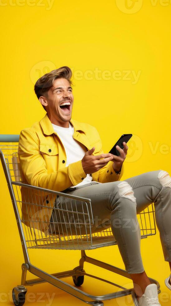 Excited man laughing and using smartphone in shopping cart trolley on yellow background AI Generated photo