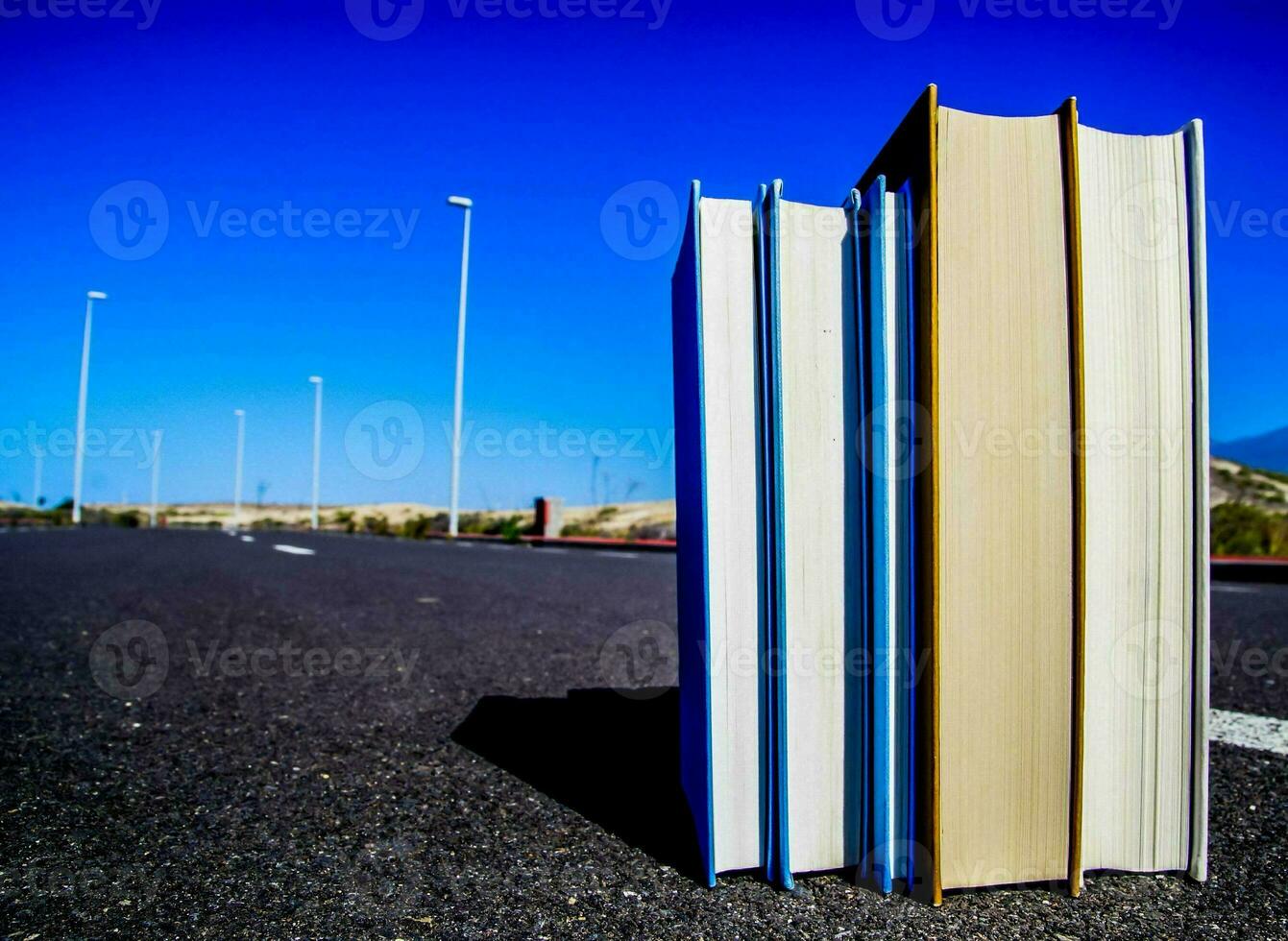 a stack of books on the road photo