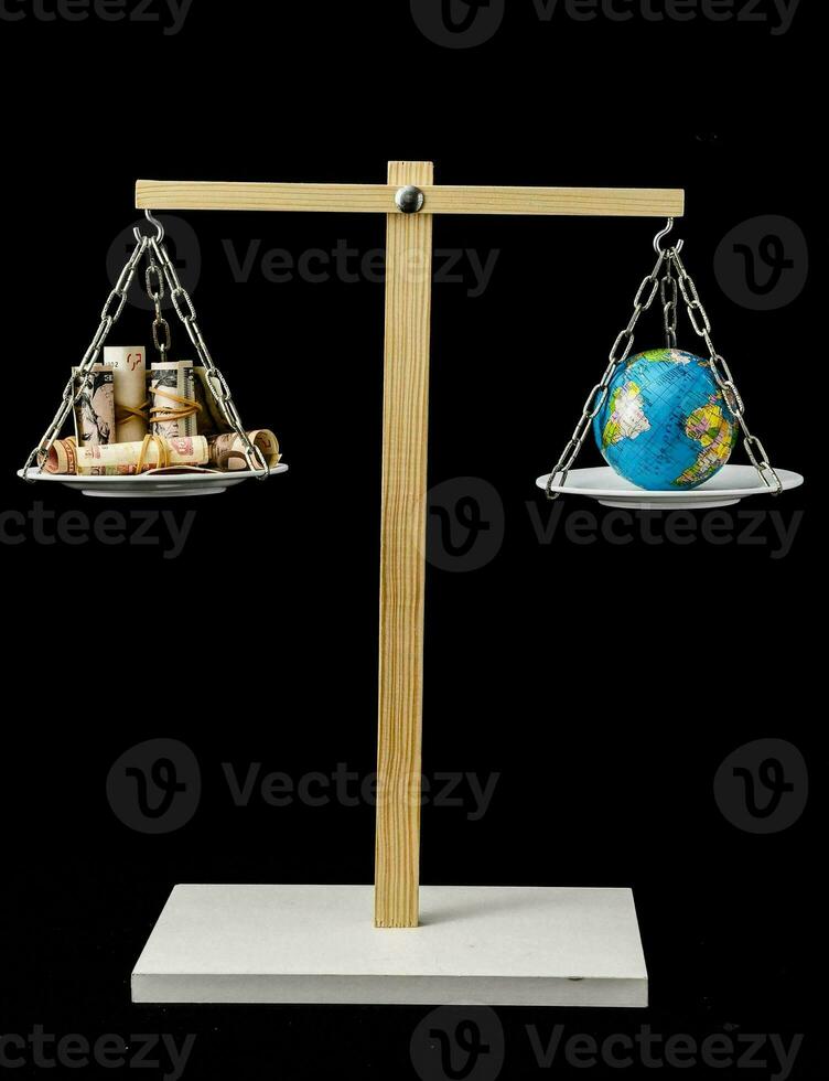 a balance of money and earth on a scale photo