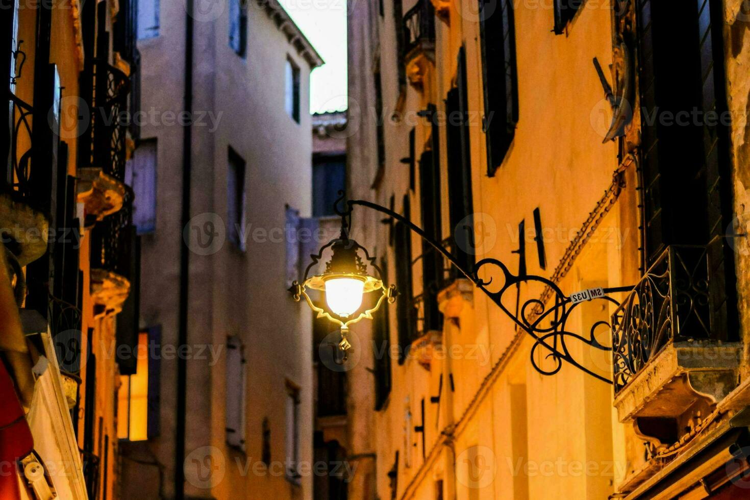 a street lamp in front of a few buildings photo