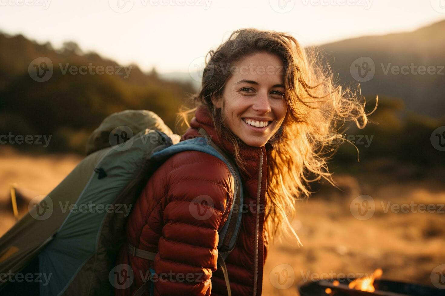Portrait of girl looking at camera while near camping tent at sunset AI generated photo