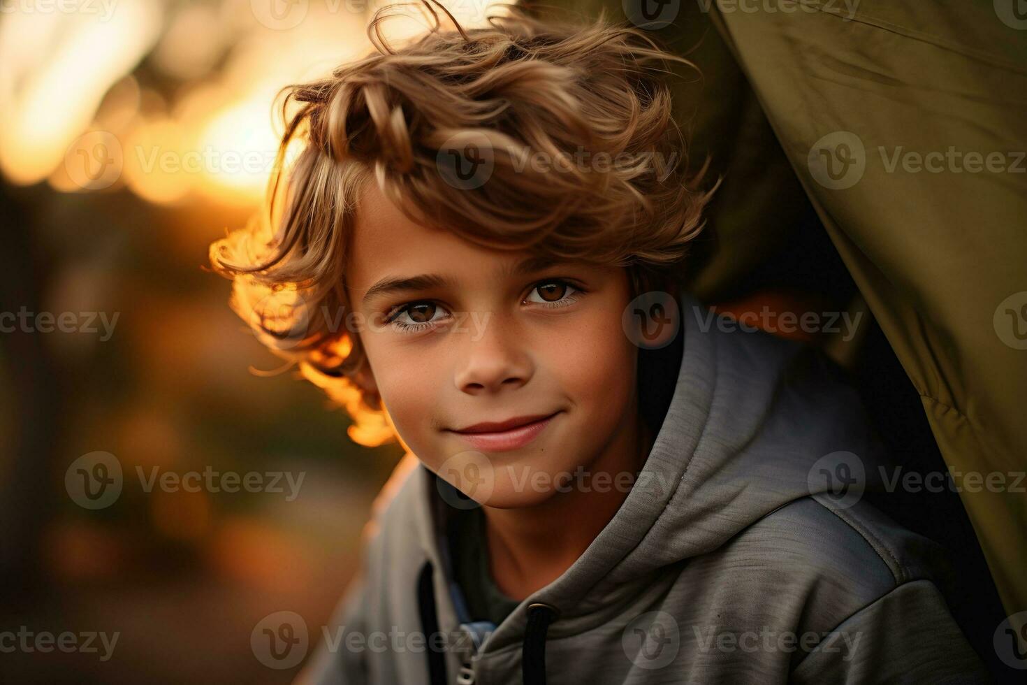 Portrait of a cute boy looking at camera while near his tent in nature AI generated photo