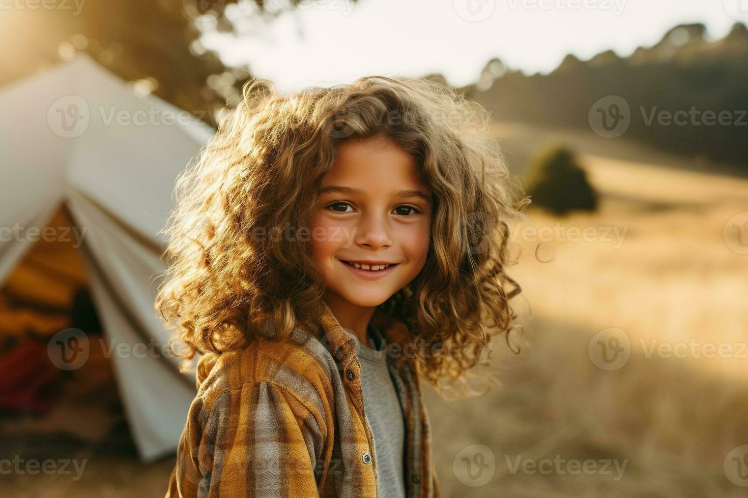 Portrait of cute little girl at camera while standing near camping tent at sunset AI generated photo