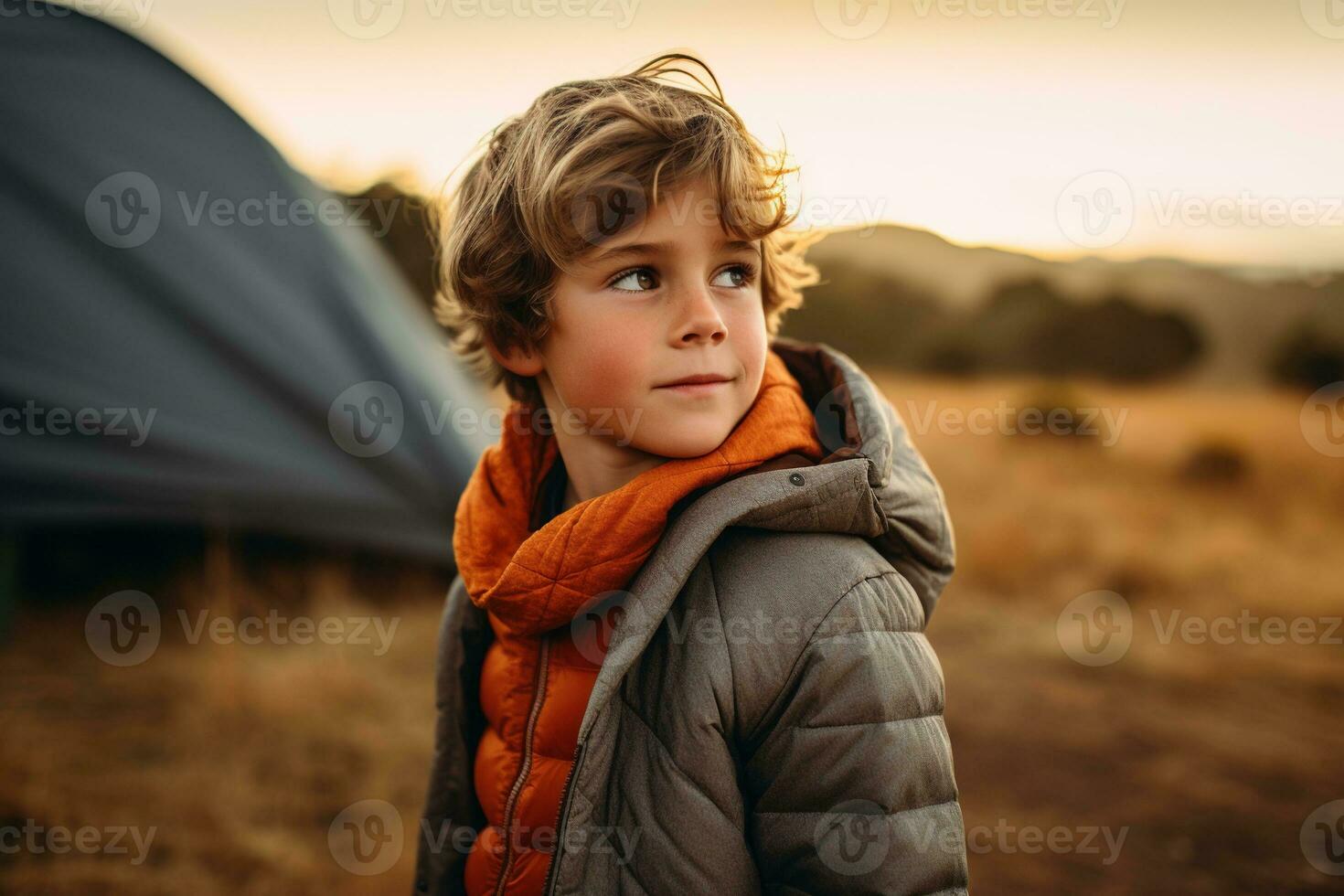 Portrait of a cute boy looking at camera while near his tent in nature AI generated photo