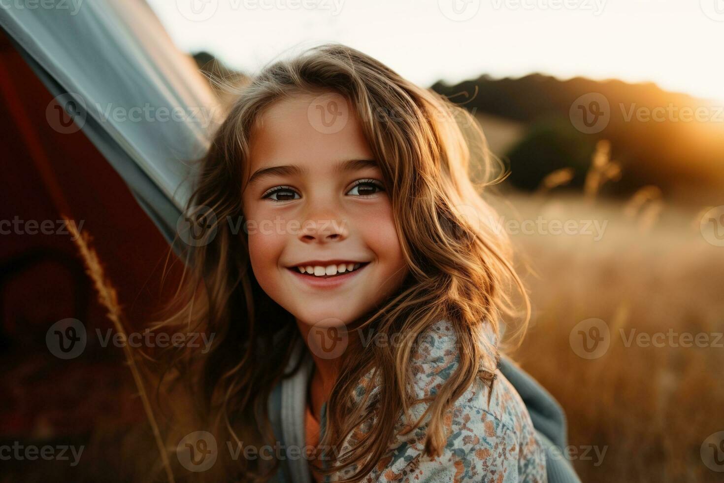 Portrait of cute little girl at camera while standing near camping tent at sunset AI generated photo