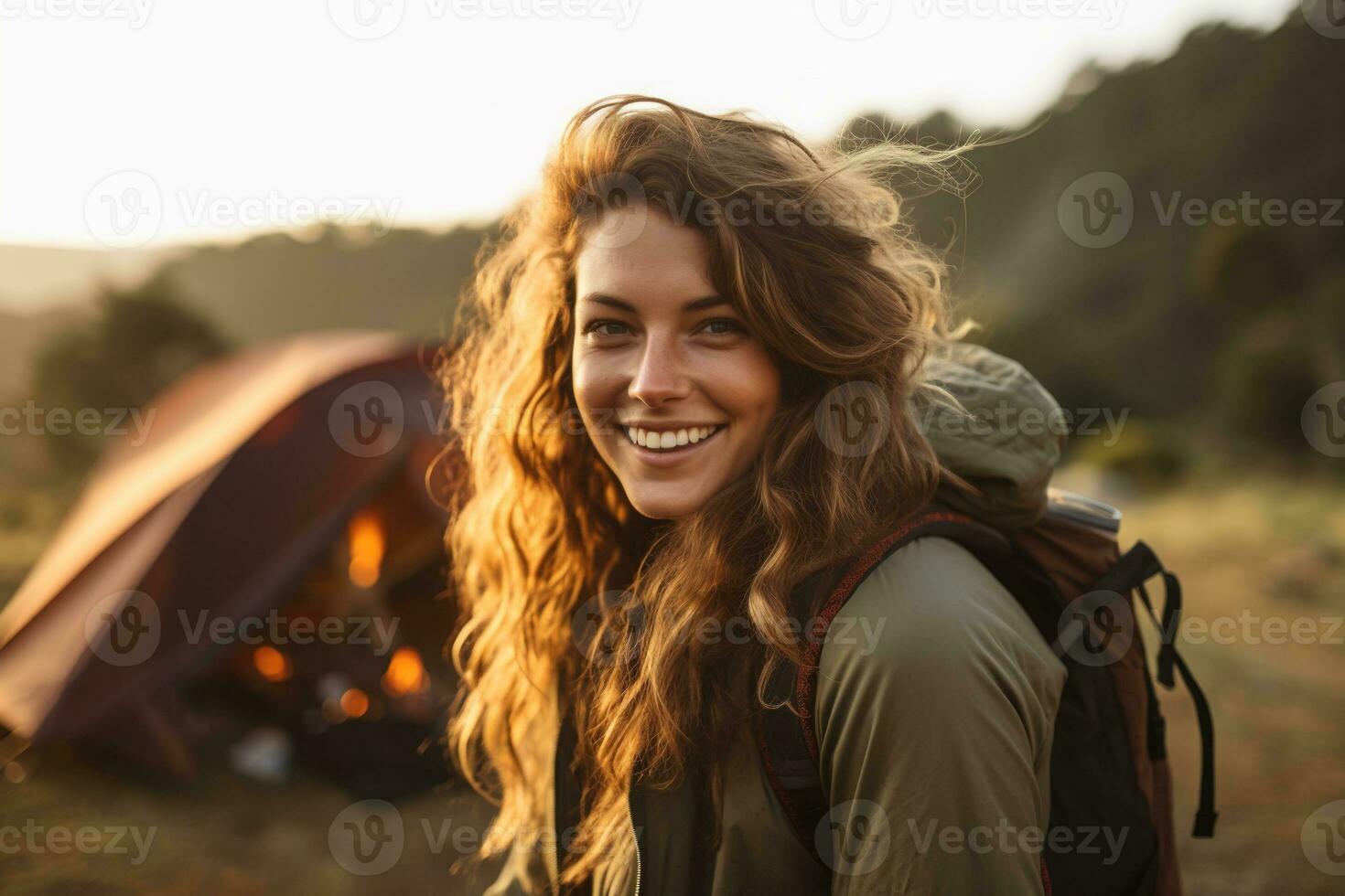 Portrait of girl looking at camera while near camping tent at sunset AI generated photo
