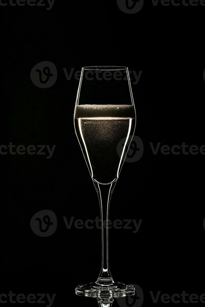 Backlit wine champagne glass with golden liquid photo