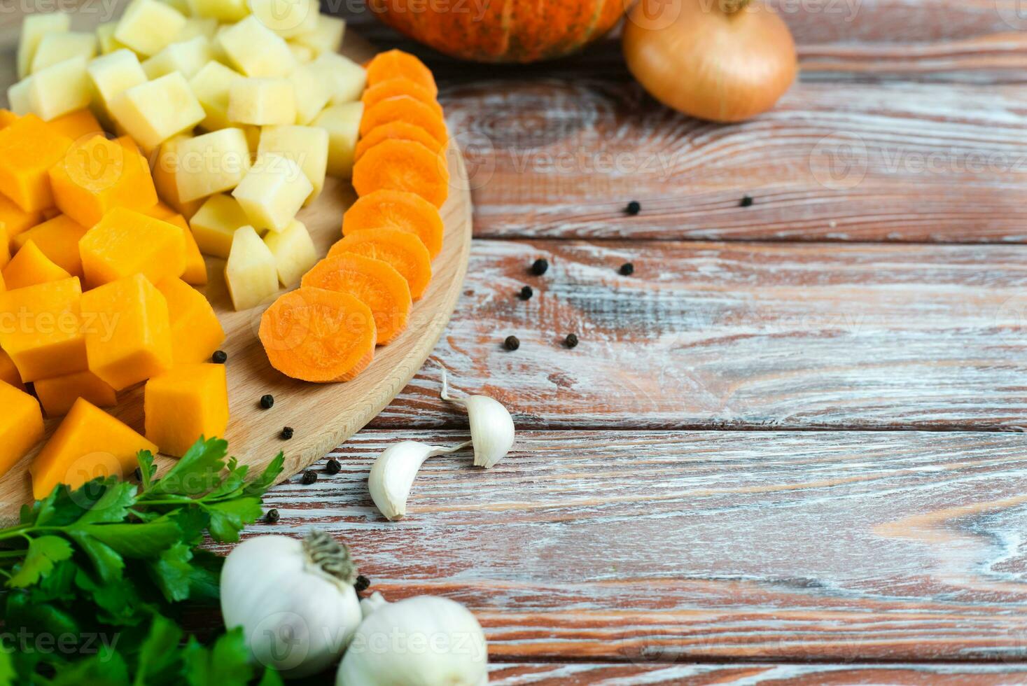 Pumpkin Soup Ingredients. Sliced seasonal vegetables pumpkin, potatoes and carrots. Copy space. photo