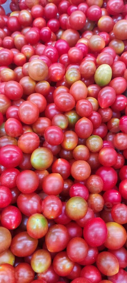 Tomatoes lying on a pile on top of each other, tomato texture. Selective focus. photo