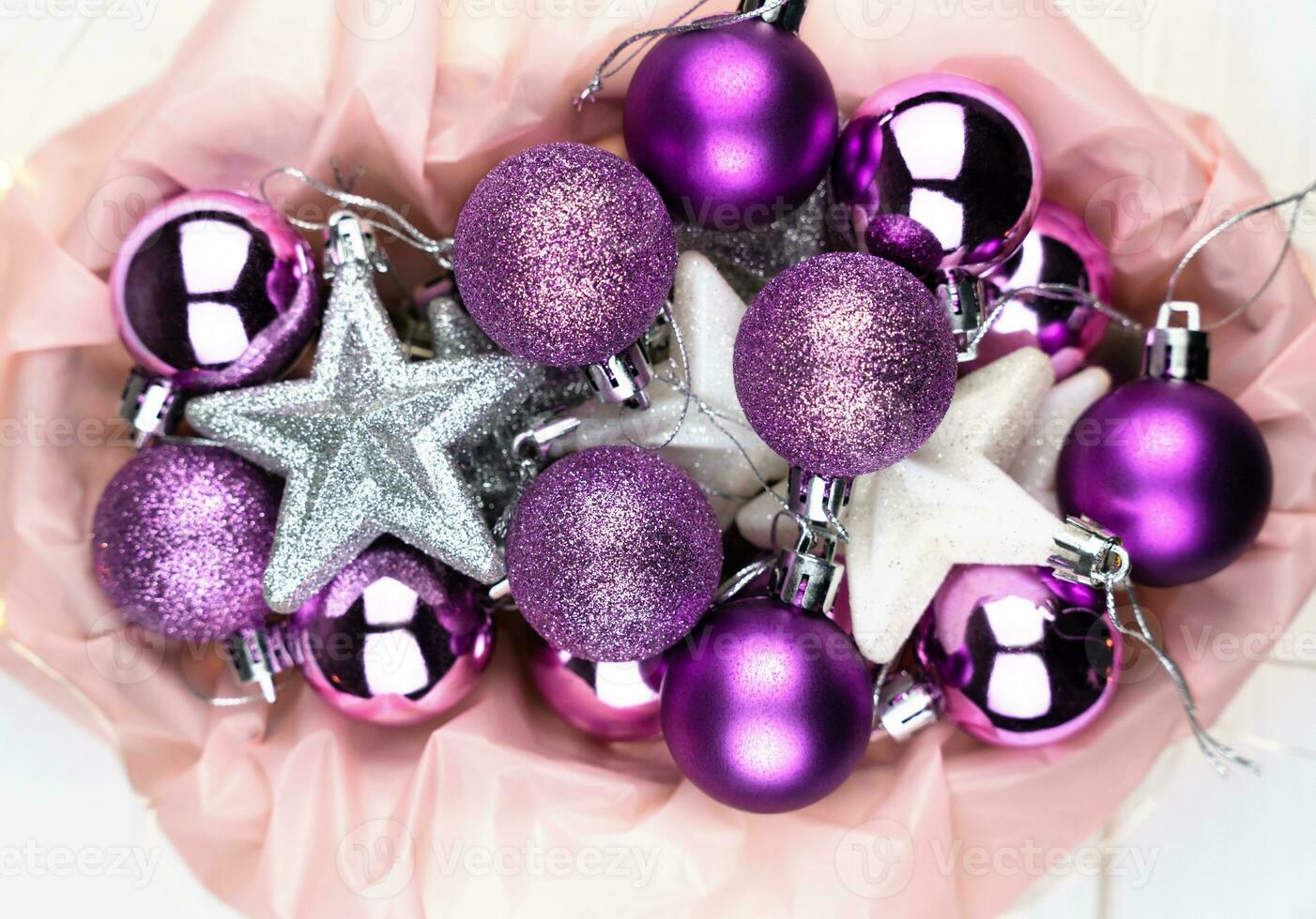 Bright beautiful Christmas decorations in a basket. Christmas tree decorations, festive mood. Top view. Close-up. Selective focus. photo