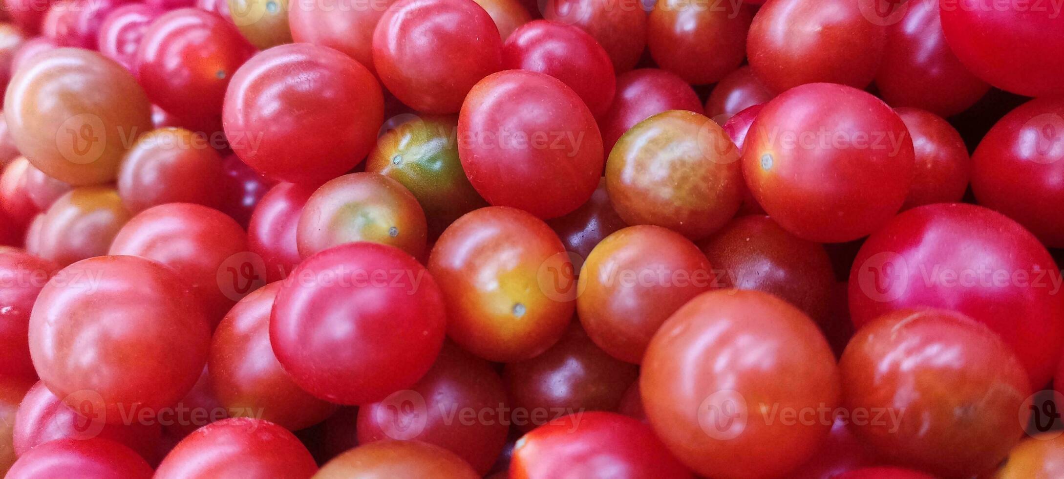 Tomatoes lying on a pile on top of each other, tomato texture. photo