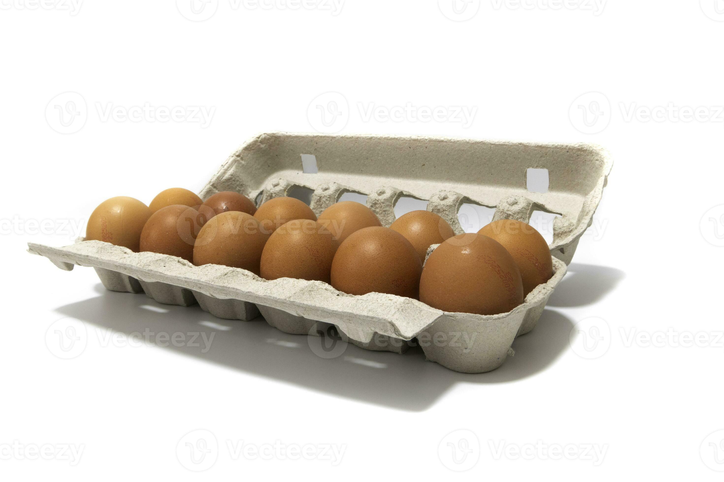 An egg carton container, with a dozen brown eggs. Isolated on a white