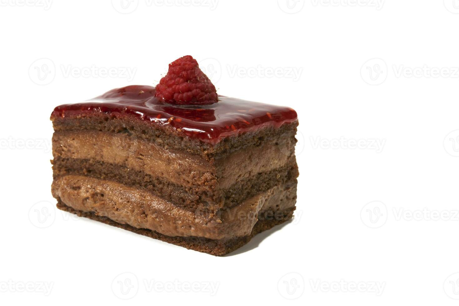 A sweet chocolate cream with a layer of raspberry jam and a raspberry on top, isolated on white background. photo