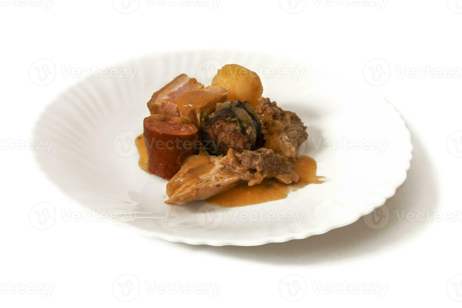 A plate of Pringa, isolated on a white background. The pringa in a chickpea stew is a rich mix of chorizo, ham and other flavorful meats, adding a hearty, savory essence to the comforting dish. photo
