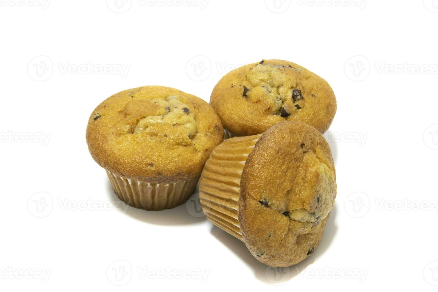 Muffins with chocolate flecks isolated on a white background. Muffins are made mainly from wheat flour, egg, vegetable oil, cow's milk, baking powder, essence ,vanilla being the most common, and sugar photo