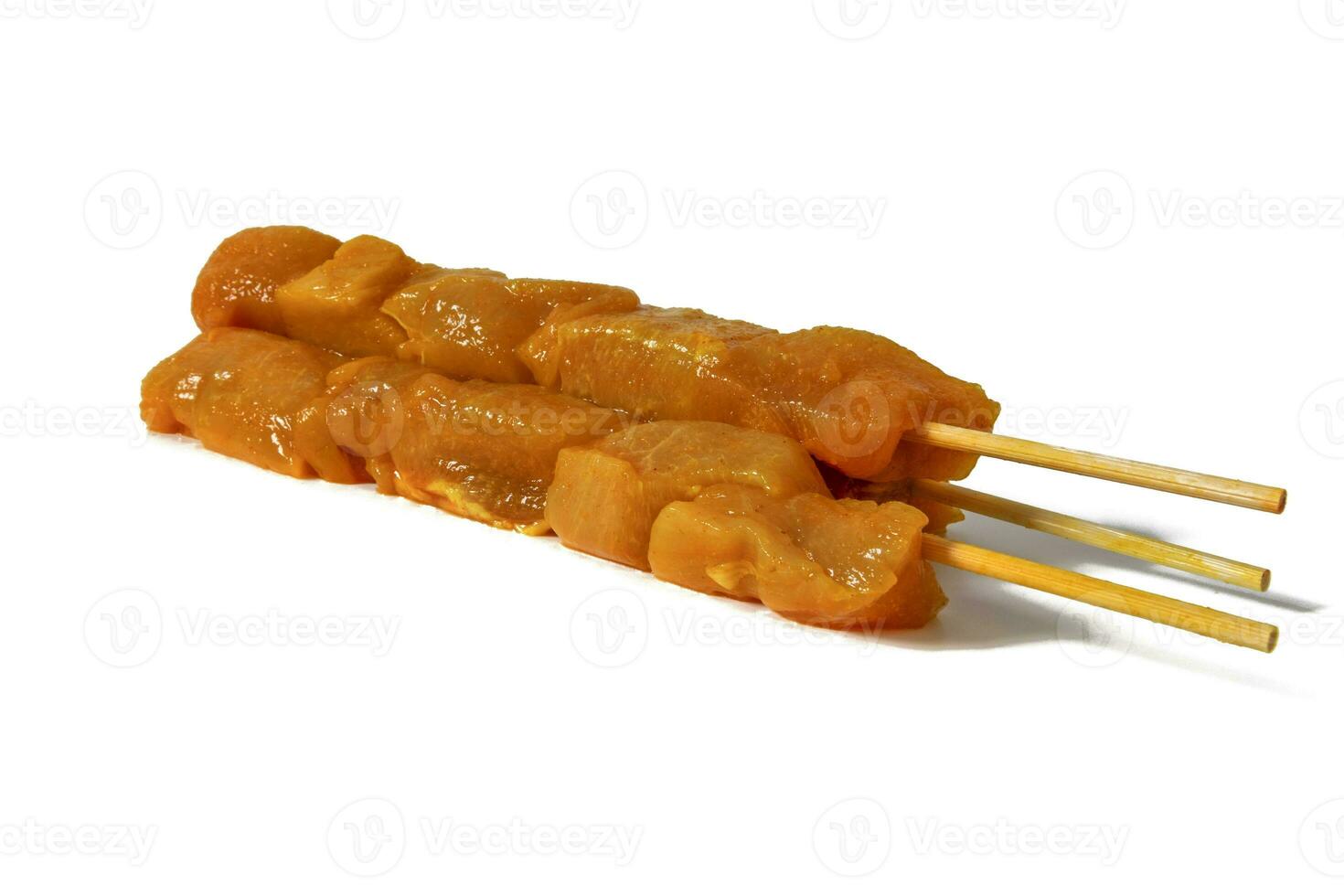 Moorish chicken pinchitos, raw chicken skewer, isolated on white background. In Andalusia, pinchitos are one of the most typical tapas in many bars. Spanish food concept. photo