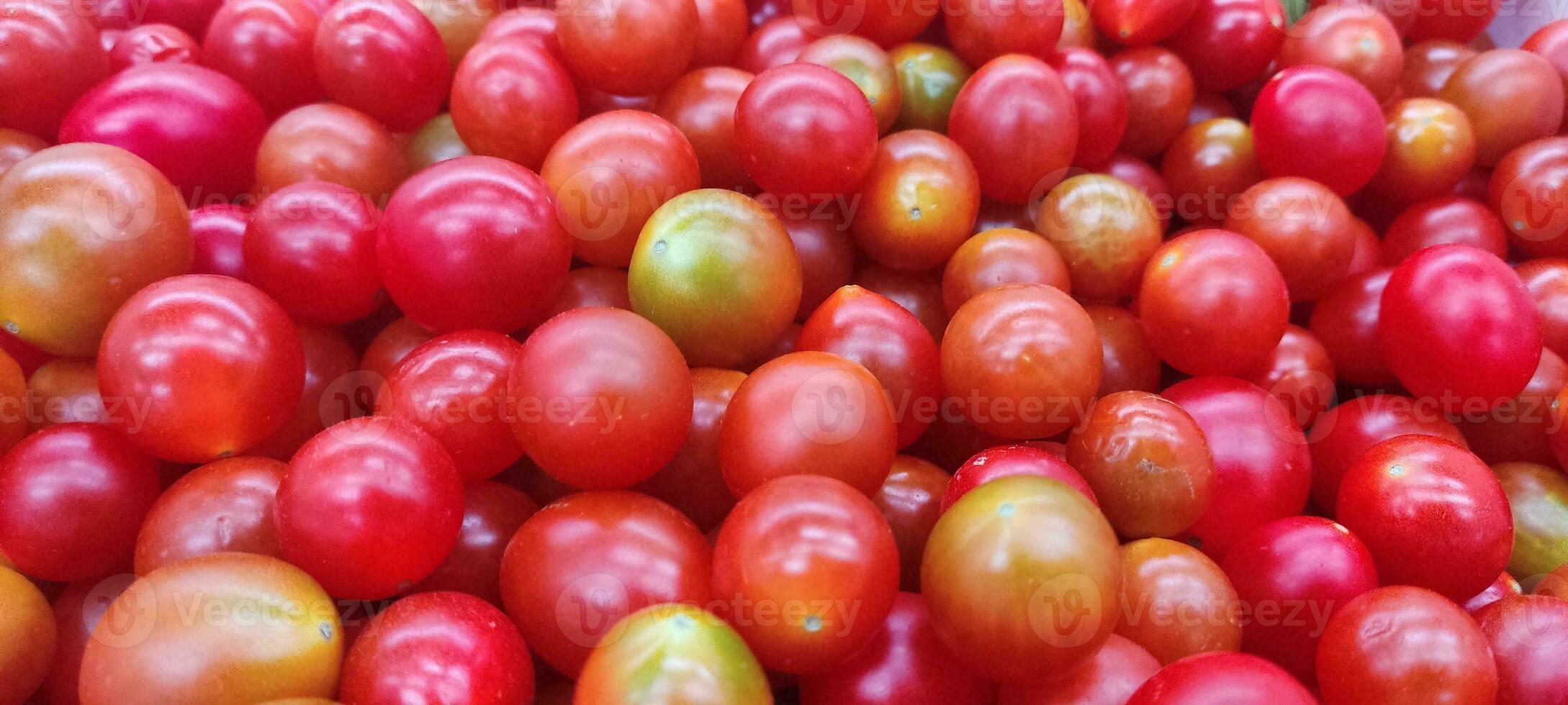 Tomatoes lying on a pile on top of each other, tomato texture. photo