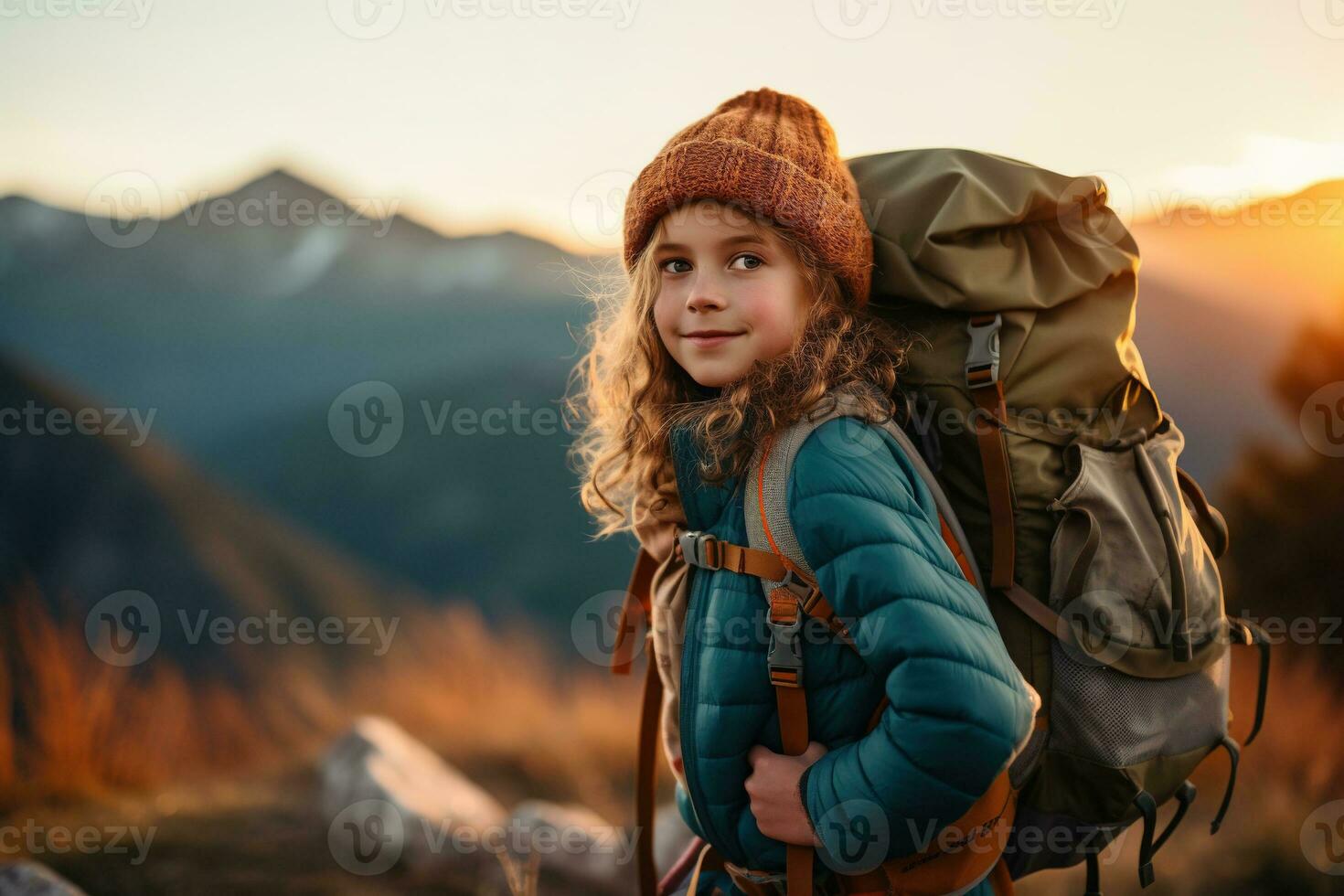 little girl with backpack hiking on mountain peak at sunset, travel and adventure concept AI generated photo
