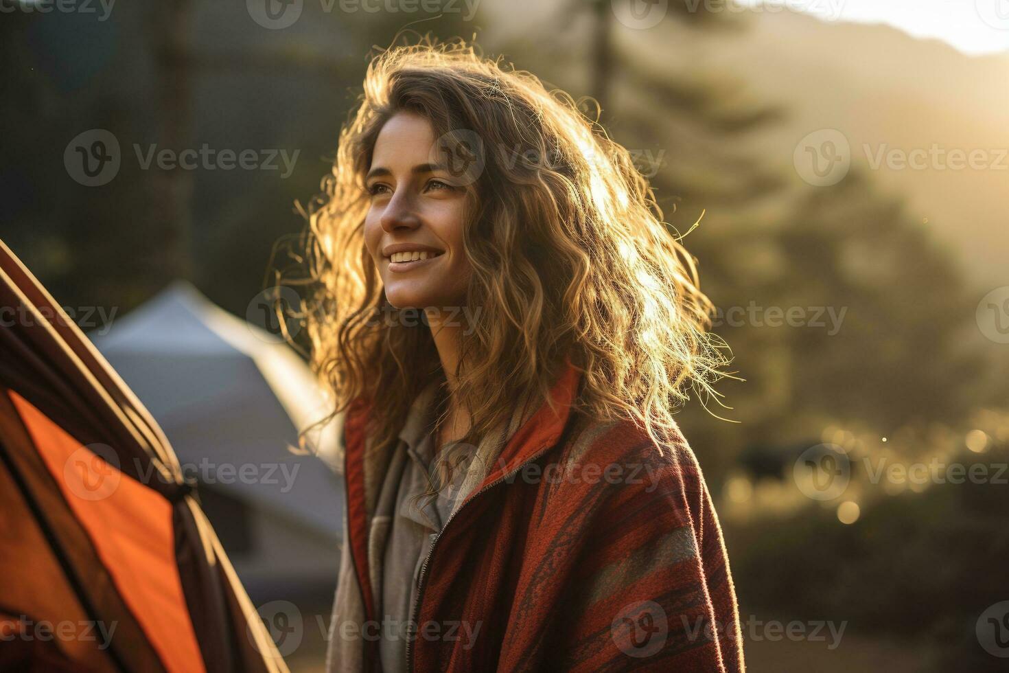 Portrait of girl looking at camera while near camping tent at sunset AI generated photo