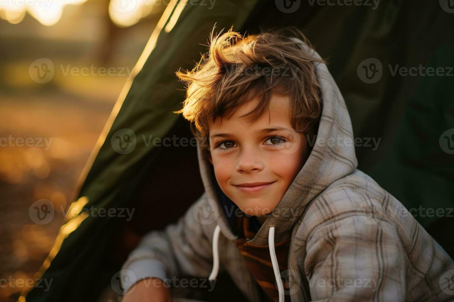 Portrait of a cute boy looking at camera while near his tent in nature AI generated photo