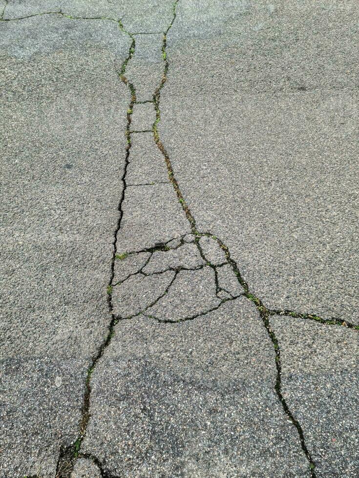 Asphalt surfaces of different streets and roads with cracks in close up photo