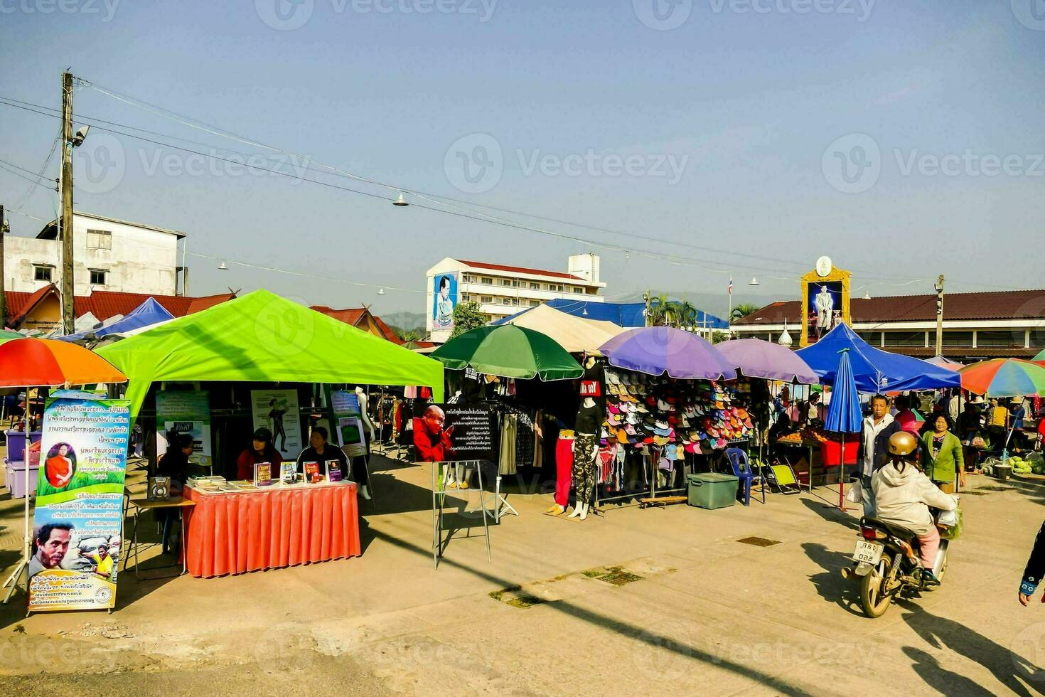 a busy street with people and vendors selling food and other items photo