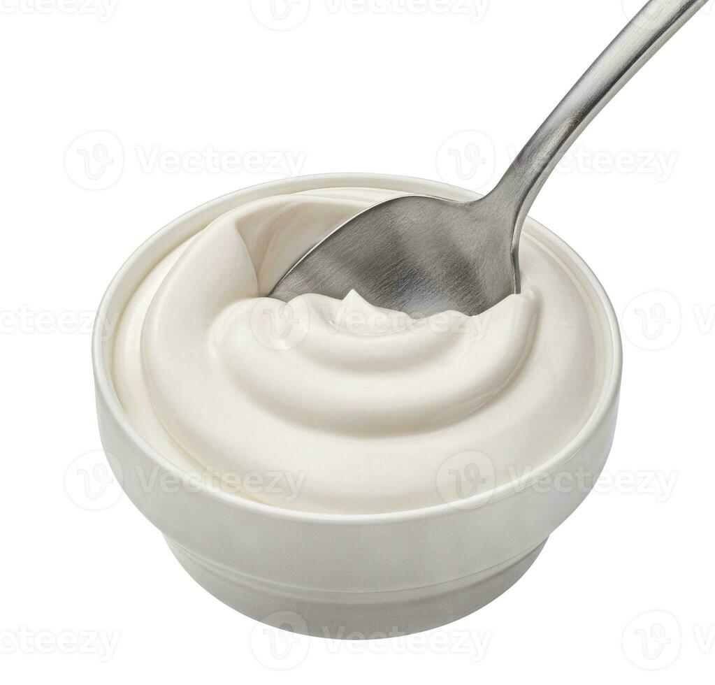 Bowl of sour cream in spoon isolated on white background, top view photo
