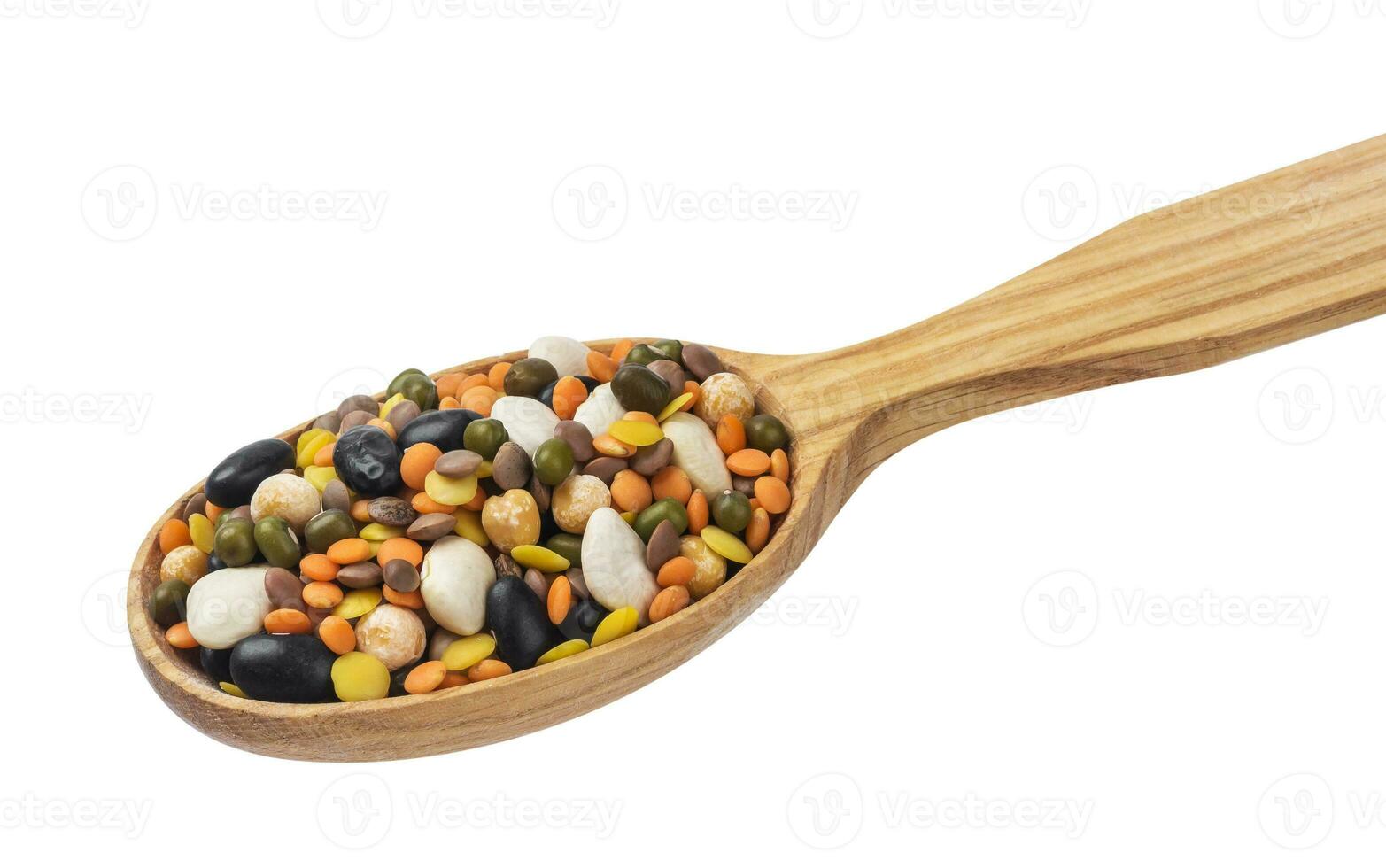 Legumes mix in wooden spoon isolated on white background. photo